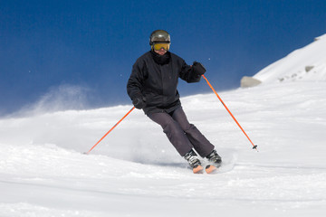 Skier skiing on ski slope