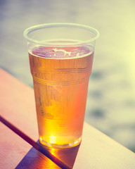 Retro styled photo of beer cup on table