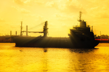 Commercial cargo ship at sunset