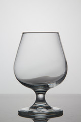 Empty glass of wine on white background