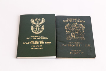 Old and new South African passports on white background