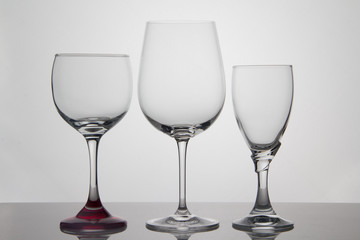 Empty glasses of wine on white background