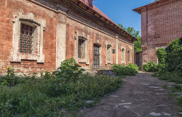 Fototapeta na wymiar Path between abandoned old buildings