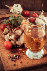 fragrant grilled meat sausages in tomato with a glass of light beer.Selective focus.Photo tinted