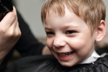 Happy boy at barbershop