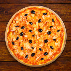 Delicious pizza with pineapple, chicken and olives