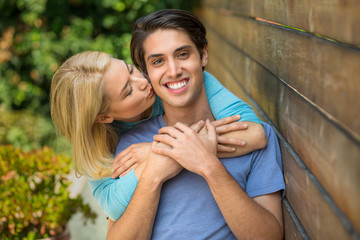 Fototapeta premium Happy couple hug and kiss with perfect teeth smile as lovers