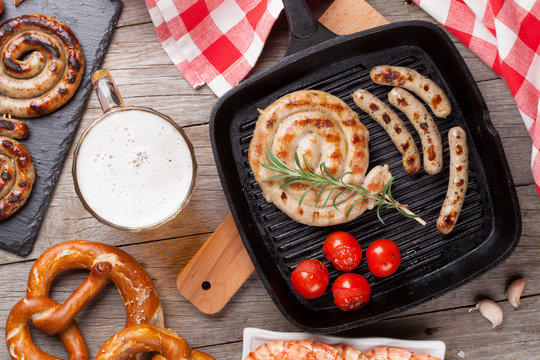 Beer mug, grilled shrimps, sausages and pretzel