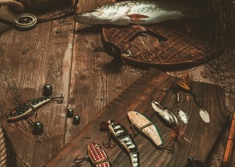 Fishing tools and fresh pike on a wooden table © Nejron Photo