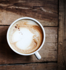 Cup of Coffee for breakfast on rustic wooden table, top view. Ca