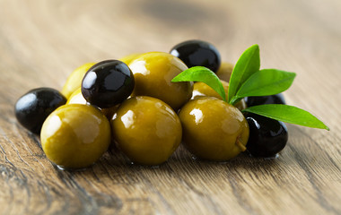 Olives  on a wooden background.