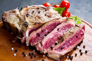 grilled sliced meat fillet on wooden background