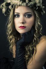 Young woman wearing feather hat