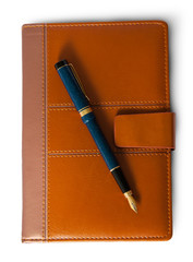 Fountain pen on top of the closed notebook top view
