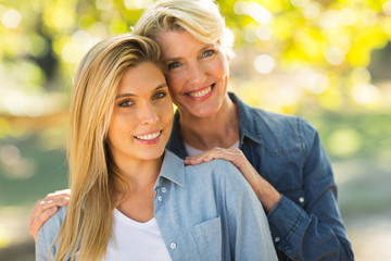 young daughter and middle aged mother outdoors