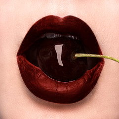 Sexy bite! A closeupcherry in her mouth.