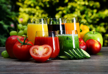 Glasses with fresh organic detox juices in the garden