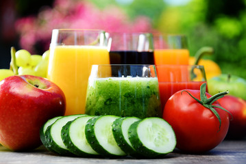 Glasses with fresh organic detox juices in the garden