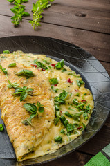 Cheese omelet with spring onions, herbs and chilli