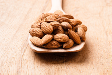 Almonds on wooden spoon