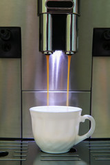 coffee machine pours coffee in cup