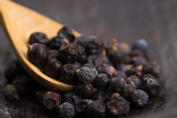 Juniper berries on a wooden background