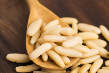 Dry Organic Pine Nuts on Wooden Background