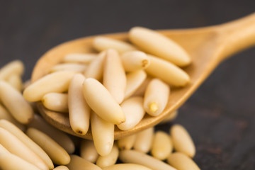 Dry Organic Pine Nuts on Wooden Background