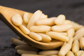 Dry Organic Pine Nuts on Wooden Background