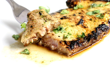 close-up isolated piece of delicios tuna steak with greenery
