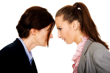 Two angry businesswomans face to face.