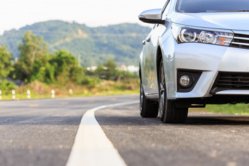 New silver car parking on the asphalt road