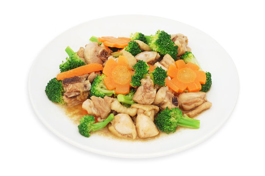 stir fried chicken with broccoli and carrot on plate isolated white background