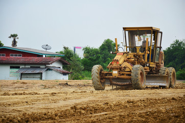 Motor grade Machine and people working at construction site