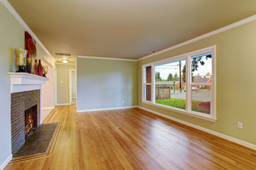 Simplistic family room with hardwood floor.