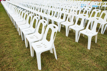 Rows of empty white chairs waiting for the audience
