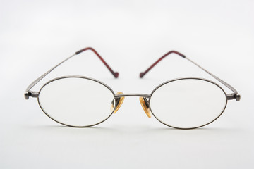 Old eye glasses on a white background.