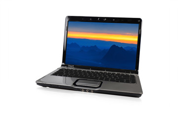 Laptop with white screen. Isolated on sunset mountain background