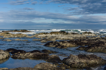 Fototapeta na wymiar Pacific coast tide pool with clouds