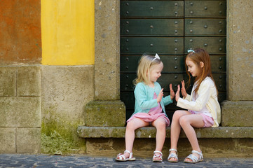 Two adorable little sisters laughing and hugging © MNStudio