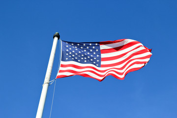 Fototapeta premium United States flag with blue sky background 