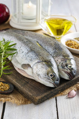 Two rainbow trouts on rustic wooden