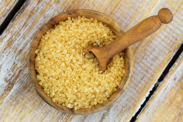 Brown sugar in bamboo bowl, closeup
