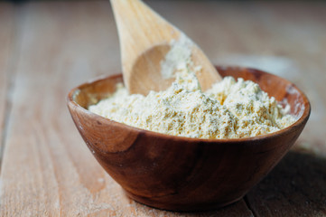 Chickpea flour in old wooden bowl