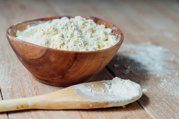 Chickpea flour in old wooden bowl