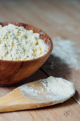Chickpea flour in old wooden bowl