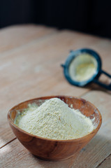 Chickpea flour in old wooden bowl