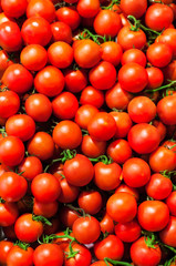 Red Cherry tomatoes in market close up, may use as background. .