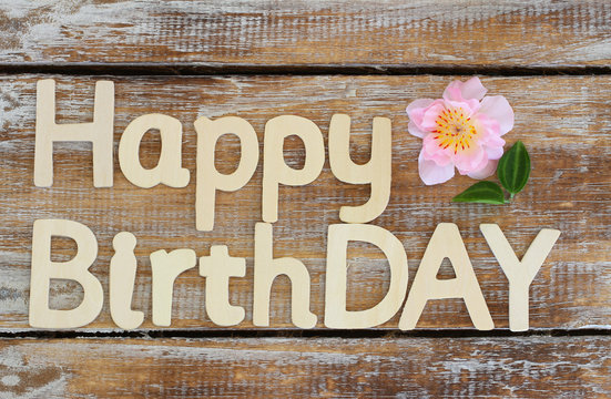 Happy birthday written with wooden letters on rustic wood
