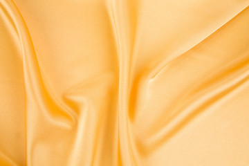 Fototapeta premium Close up of yellow silk cloth texture.